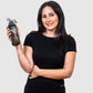 woman holding a gym water bottle that can spray mist water on the face for refreshment. 