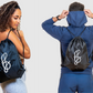 a girl and guy wearing and holding a shower drawstring gym bag