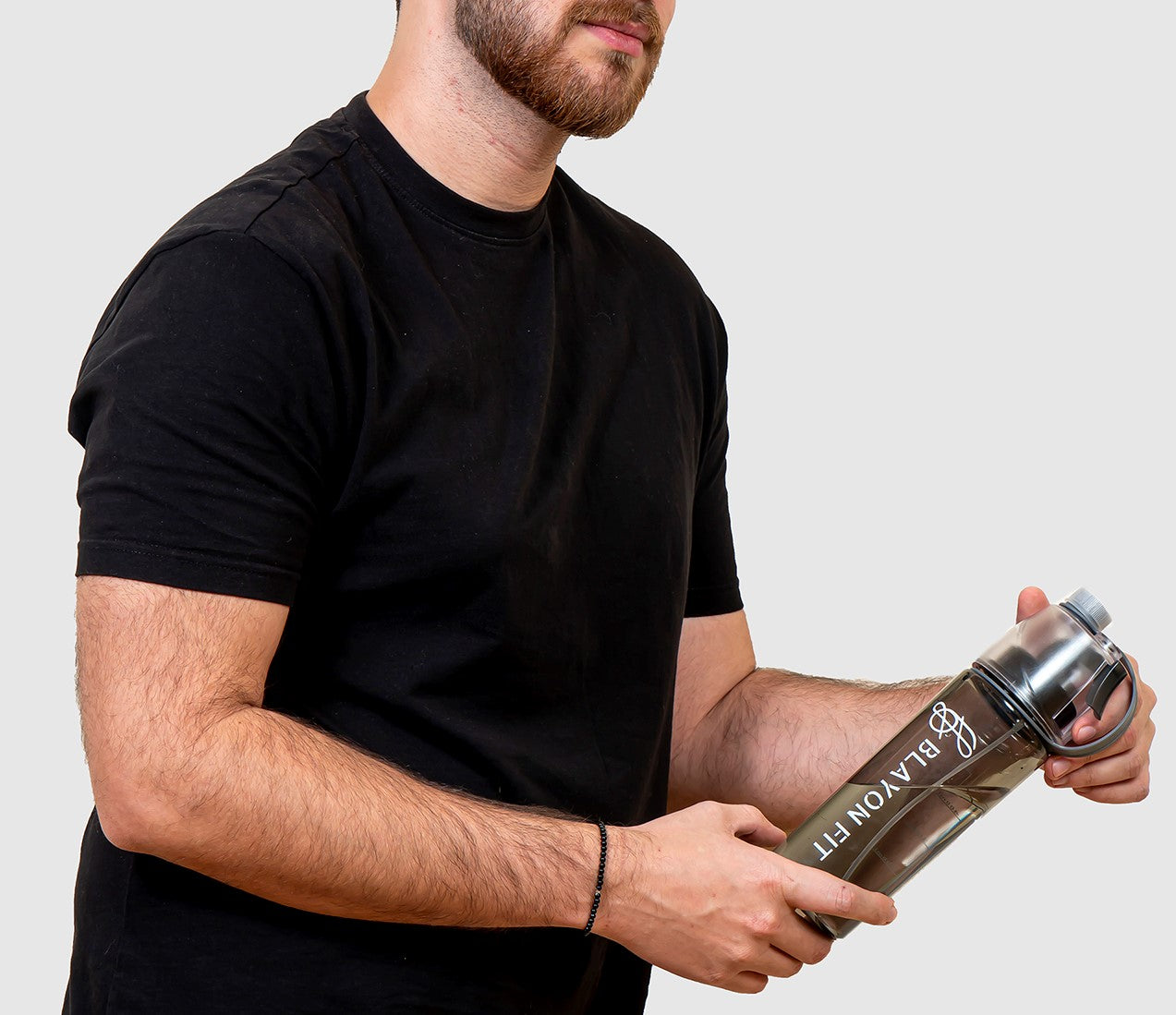 man holding a spray gym water bottle for refreshment